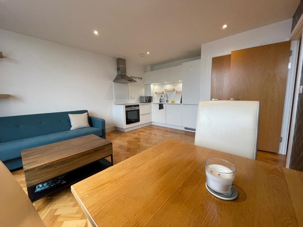 Lot: 102 - ONE-BEDROOM 4TH FLOOR CITY CENTRE APARTMENT - Living Room and Kitchen with parquet wooden flooring in city centre apartment going to auction
